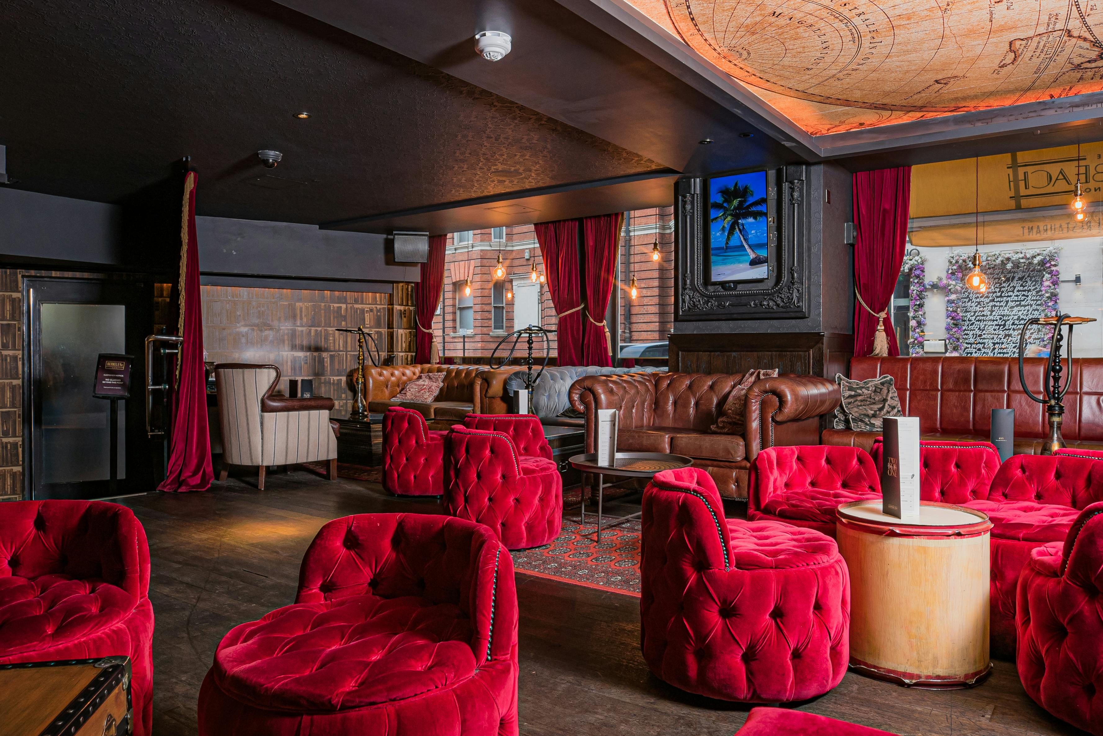 Stylish lounge with plush red seating, ideal for intimate gatherings and networking events.