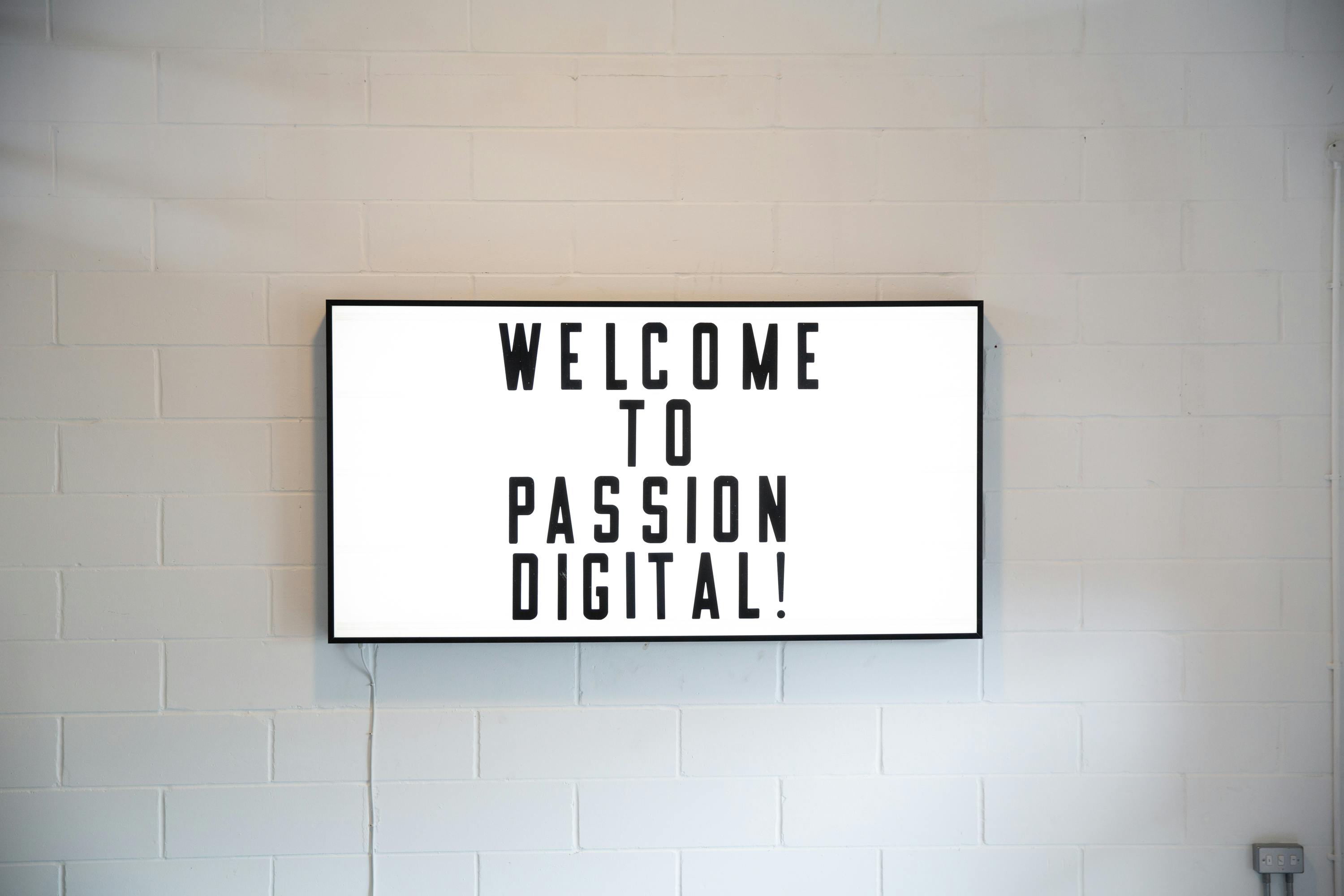 "Whole Mezzanine digital display welcoming attendees to a professional event."
