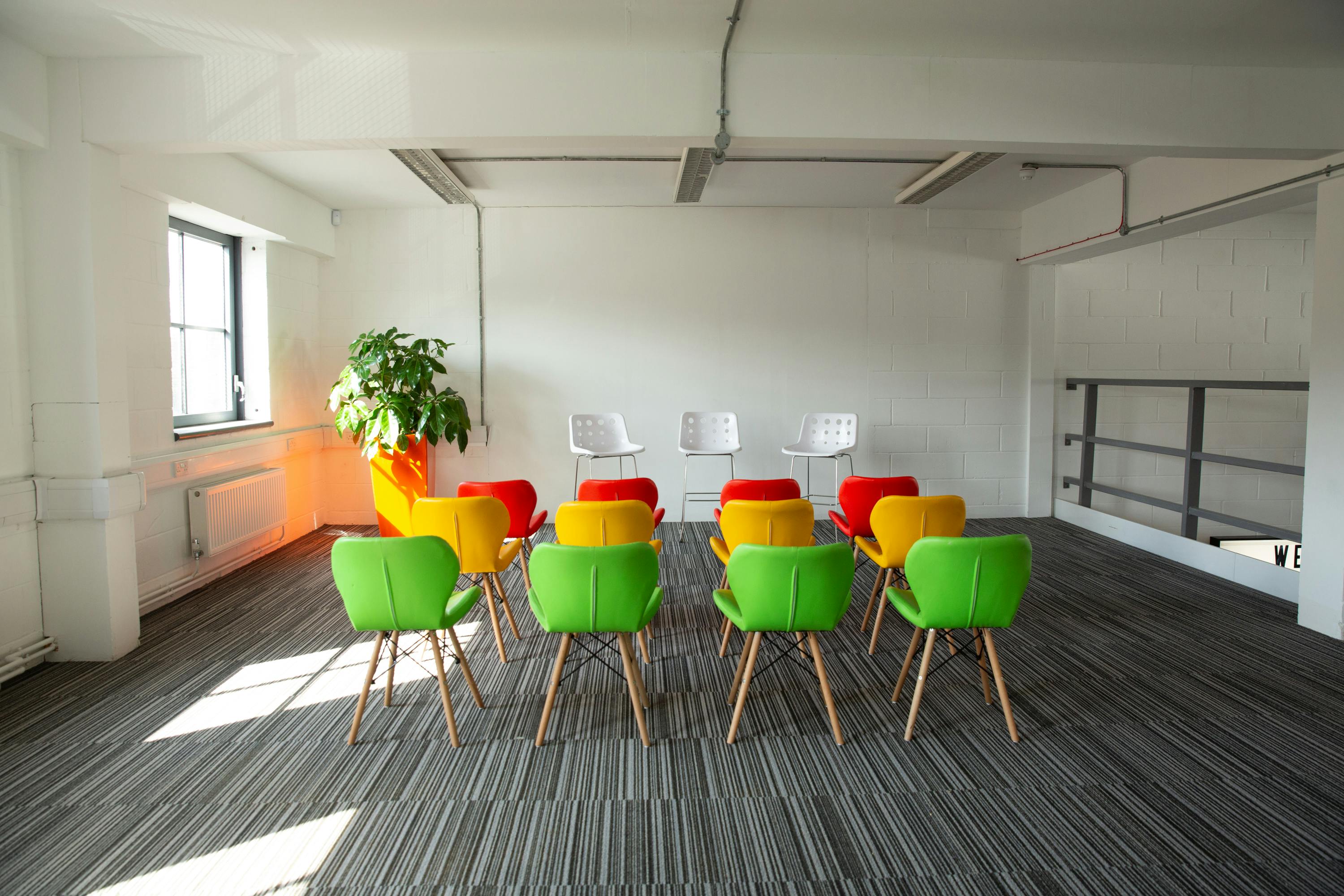 Vibrant meeting space with colorful chairs for collaborative workshops in Union Court.