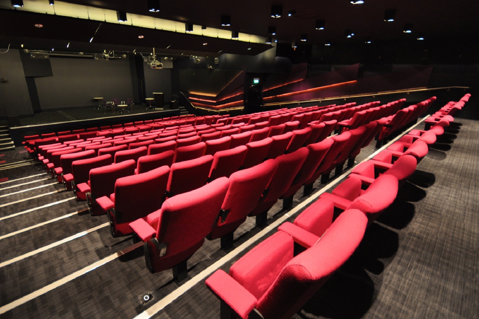 Weston Theatre auditorium with red seating, ideal for conferences and performances.
