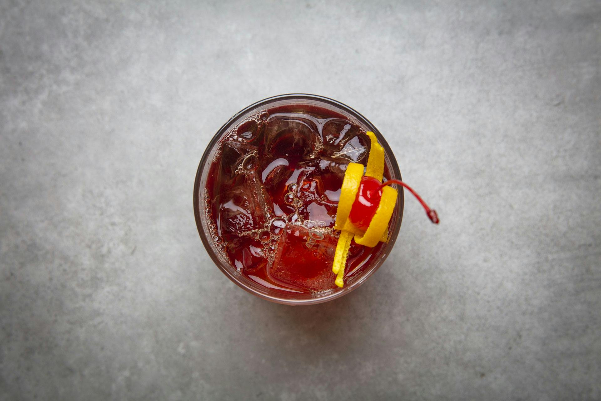 Vibrant cocktail with cherry garnish, perfect for networking events and celebrations.