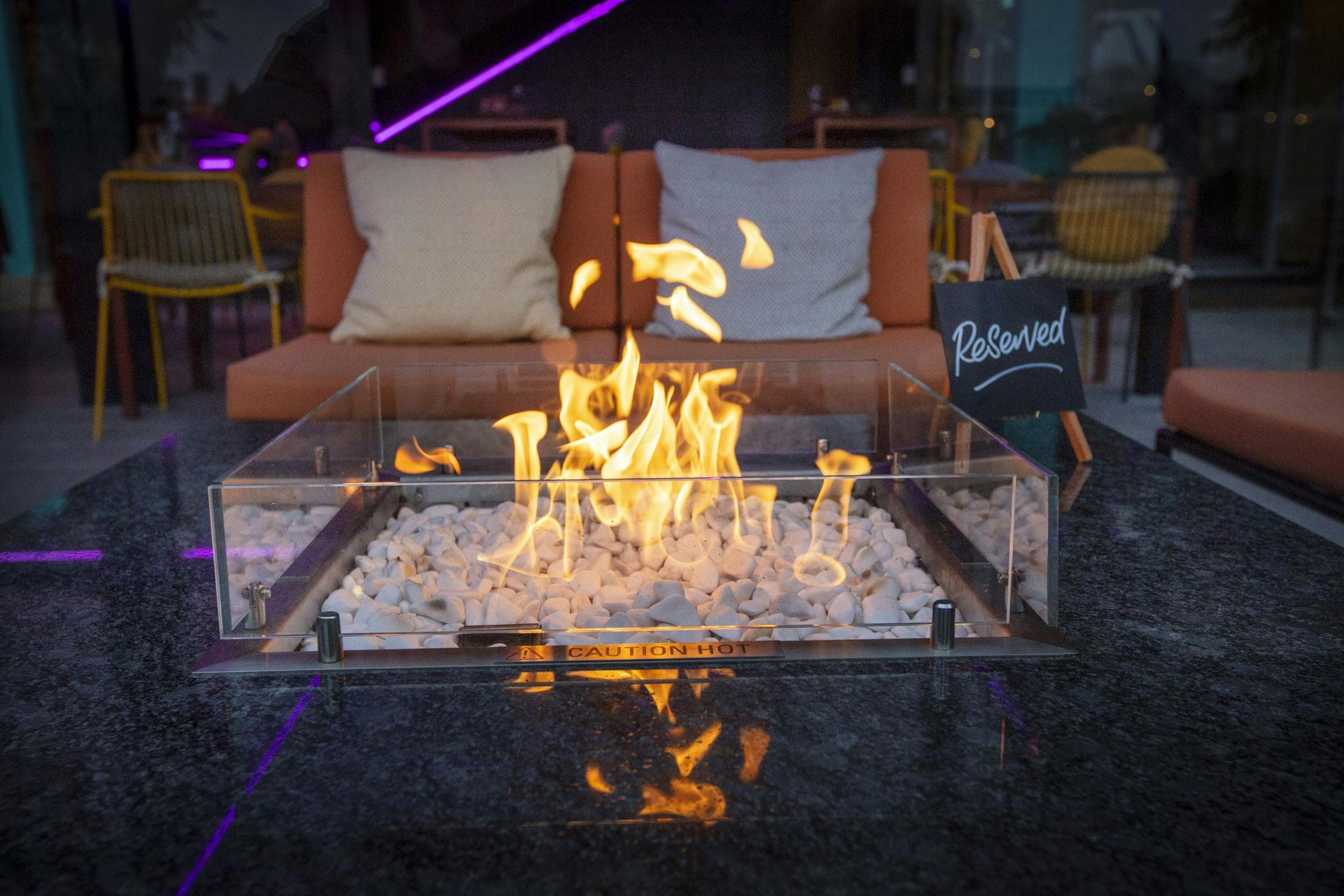 Stylish outdoor lounge with modern fire pit, perfect for events and networking in London.