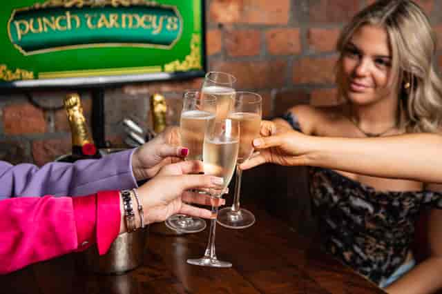 Celebratory toast with elegant flutes at Punch Tarmey's Liverpool event.