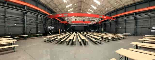 Spacious event venue with high ceilings, ideal for conferences and gatherings.