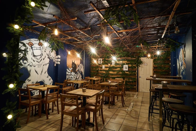 Secret Garden Room in BATCH with rustic tables, ideal for intimate events and gatherings.