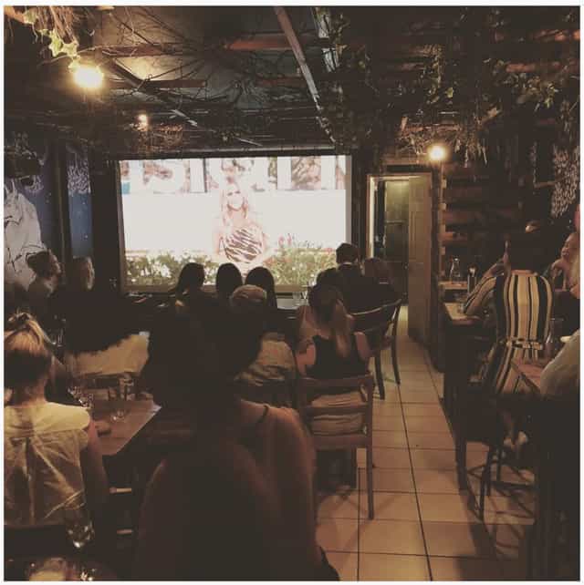 Cozy Secret Garden Room set for a screening event with ambient lighting and seating.
