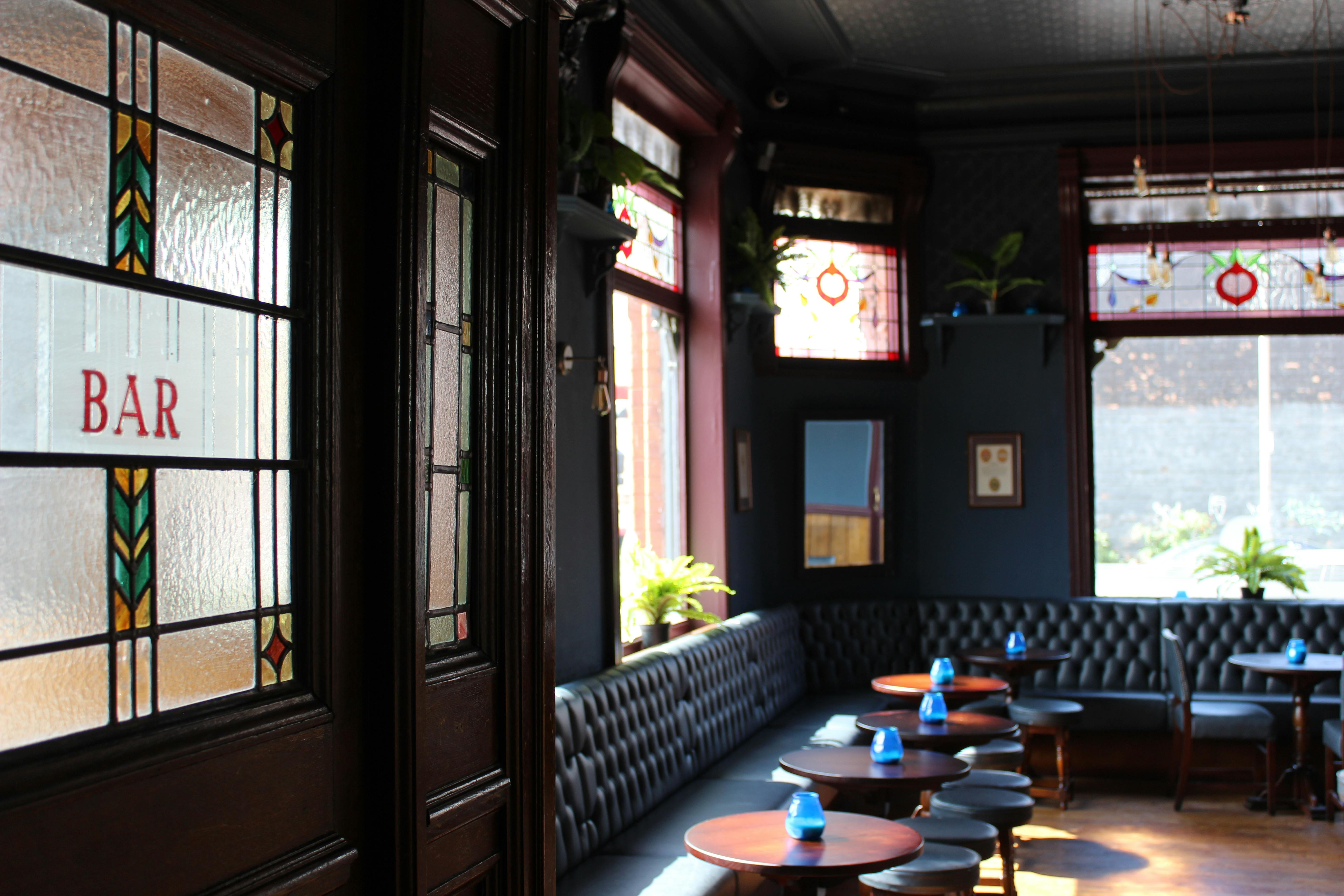 Stylish bar area with stained glass, perfect for networking events and casual meetings.