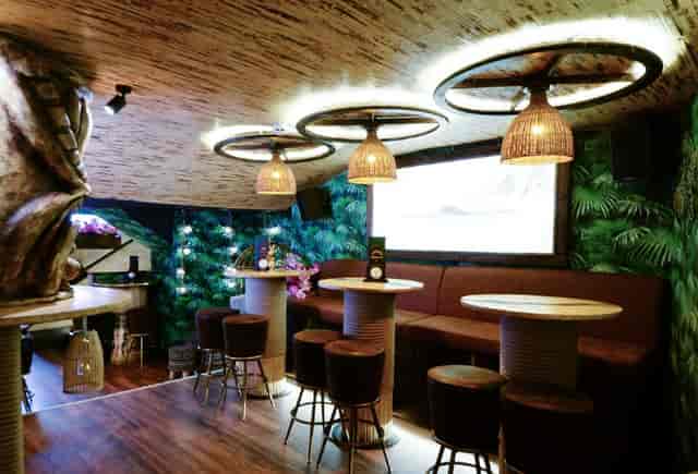 Intimate event space at Laki Kane with warm lighting and lush greenery for gatherings.