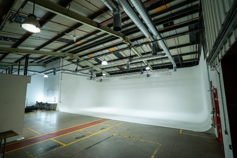 Spacious Studio One event space with white backdrop for corporate meetings and creative events.