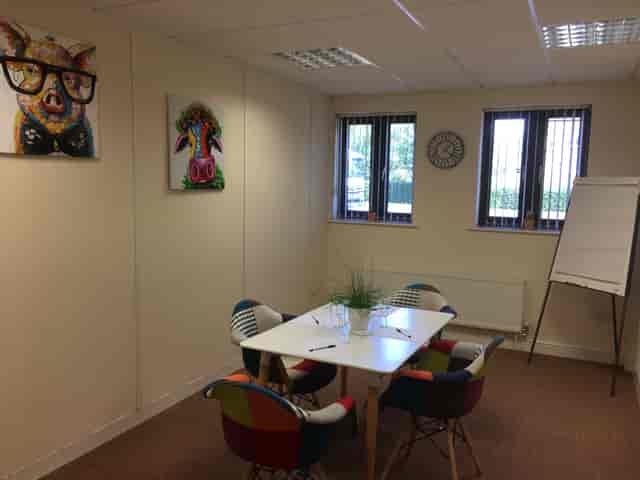 The Cow Shed meeting room at UBC Cirencester with colorful chairs for brainstorming sessions.
