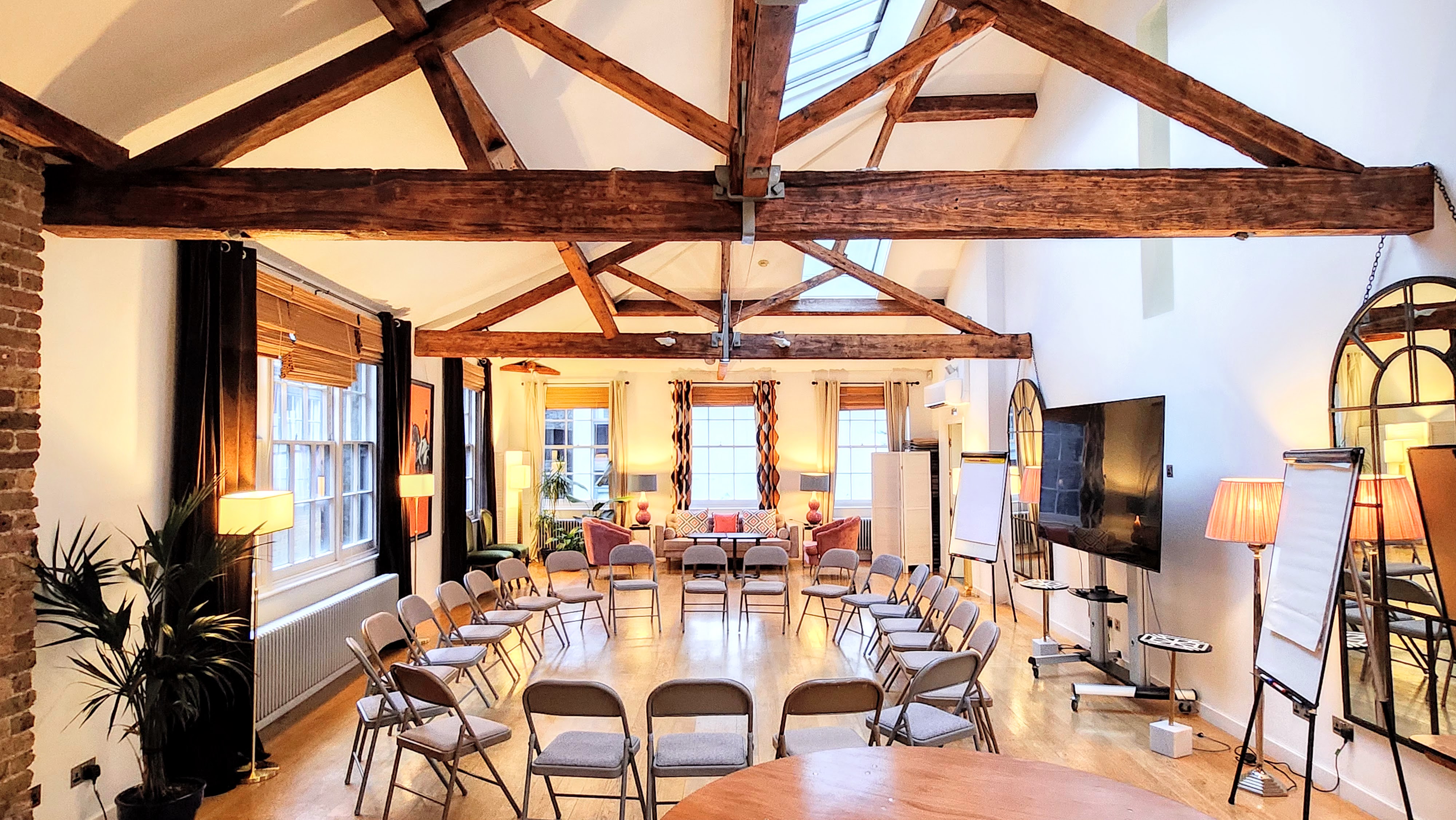 Whole Venue in Lumiere London: bright meeting space with circular chairs for workshops. - Banner