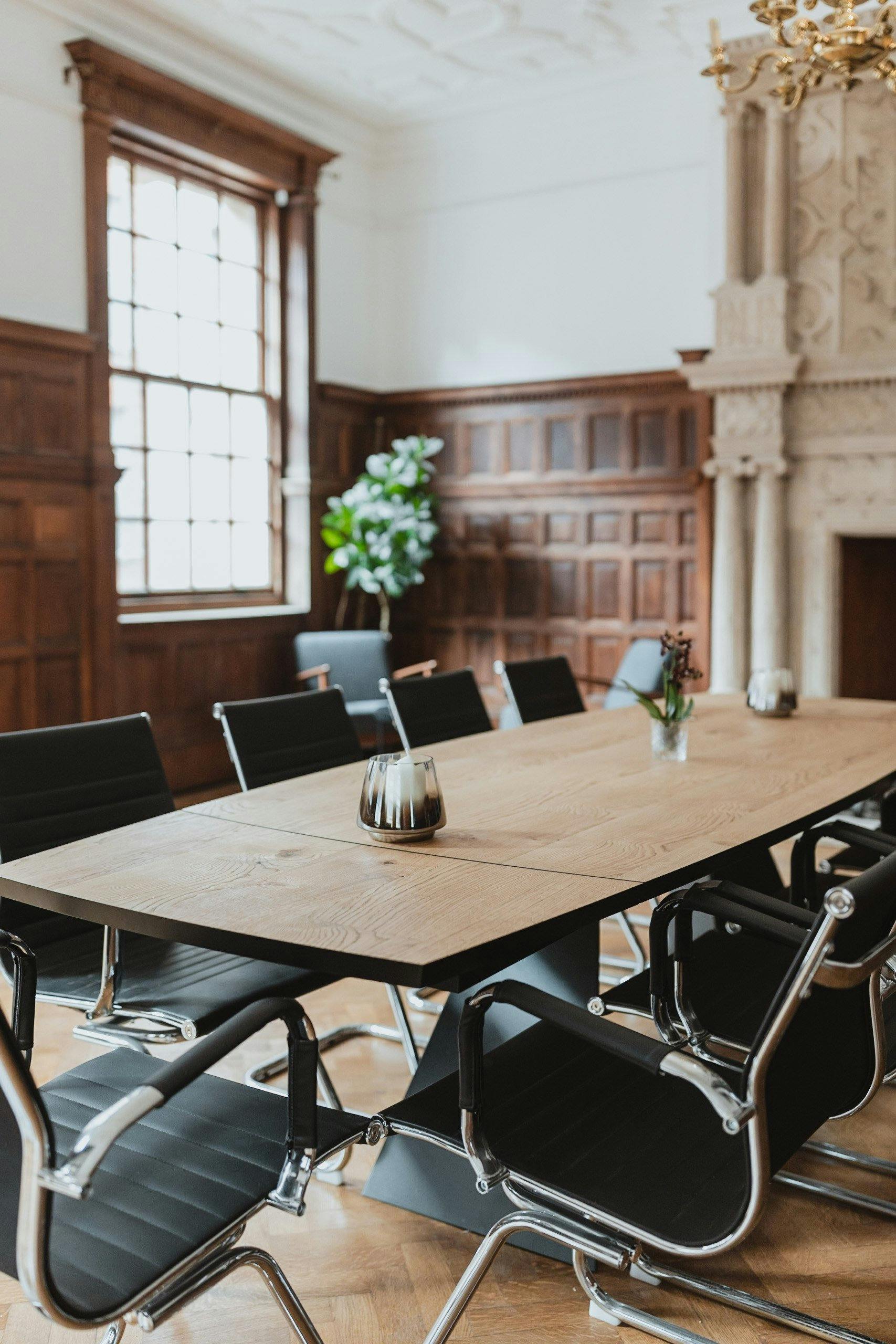 Meeting room at The Brunel, wooden table, ideal for strategic discussions and gatherings.