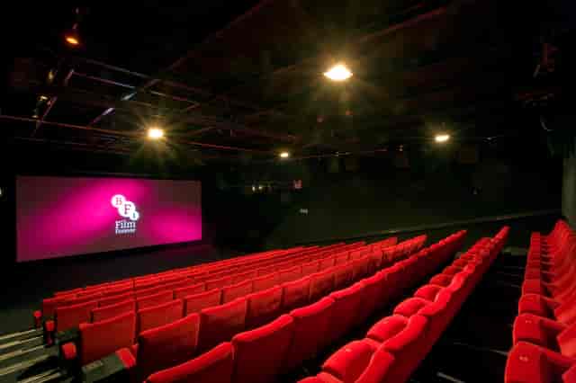 Modern screening room with plush red seating for film festivals and corporate events.