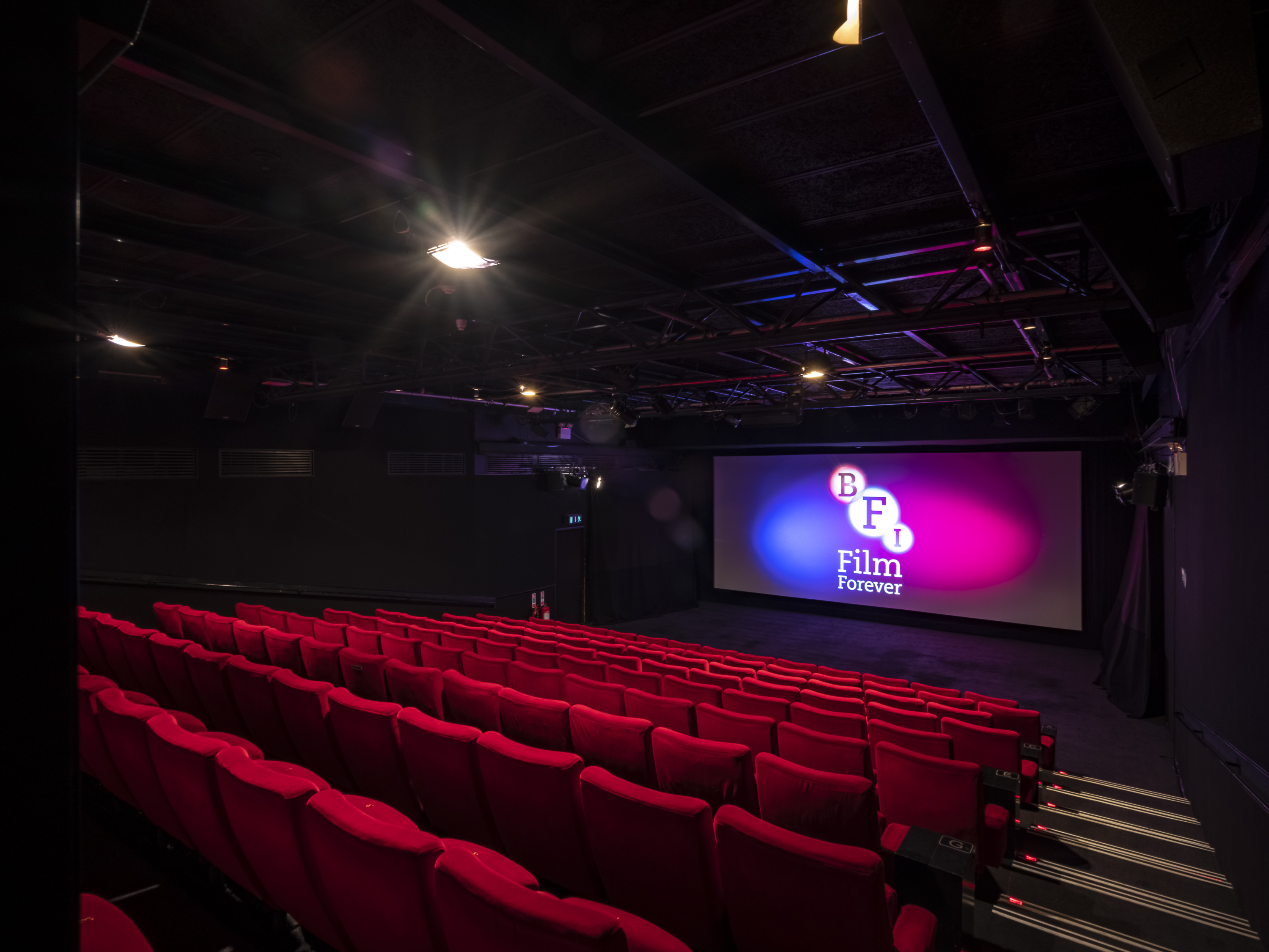 Modern cinema at BFI Southbank with vibrant red seating for film screenings. - Banner