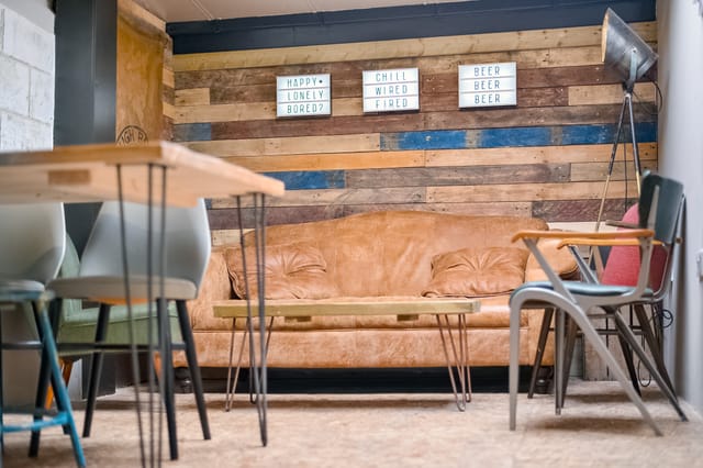 Cozy Taproom at Sambrook's Brewery with leather couch, ideal for meetings and workshops.