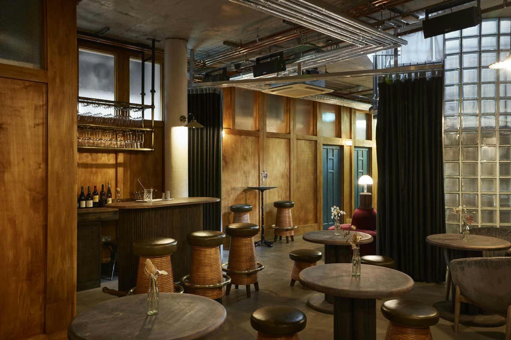 Stylish Downstairs bar in Lino with warm wood accents for intimate events and meetings.