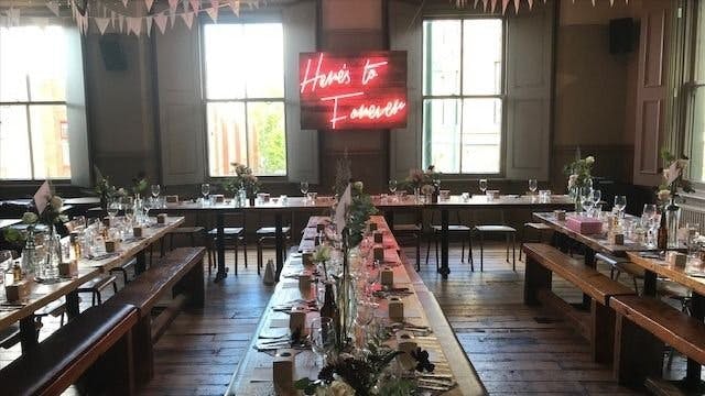 Eyrie Room event space with elegant table settings for gatherings and natural light.