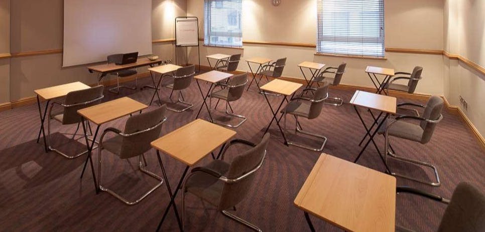 Meeting room setup with desks for training session at Jury's Inn Glasgow.