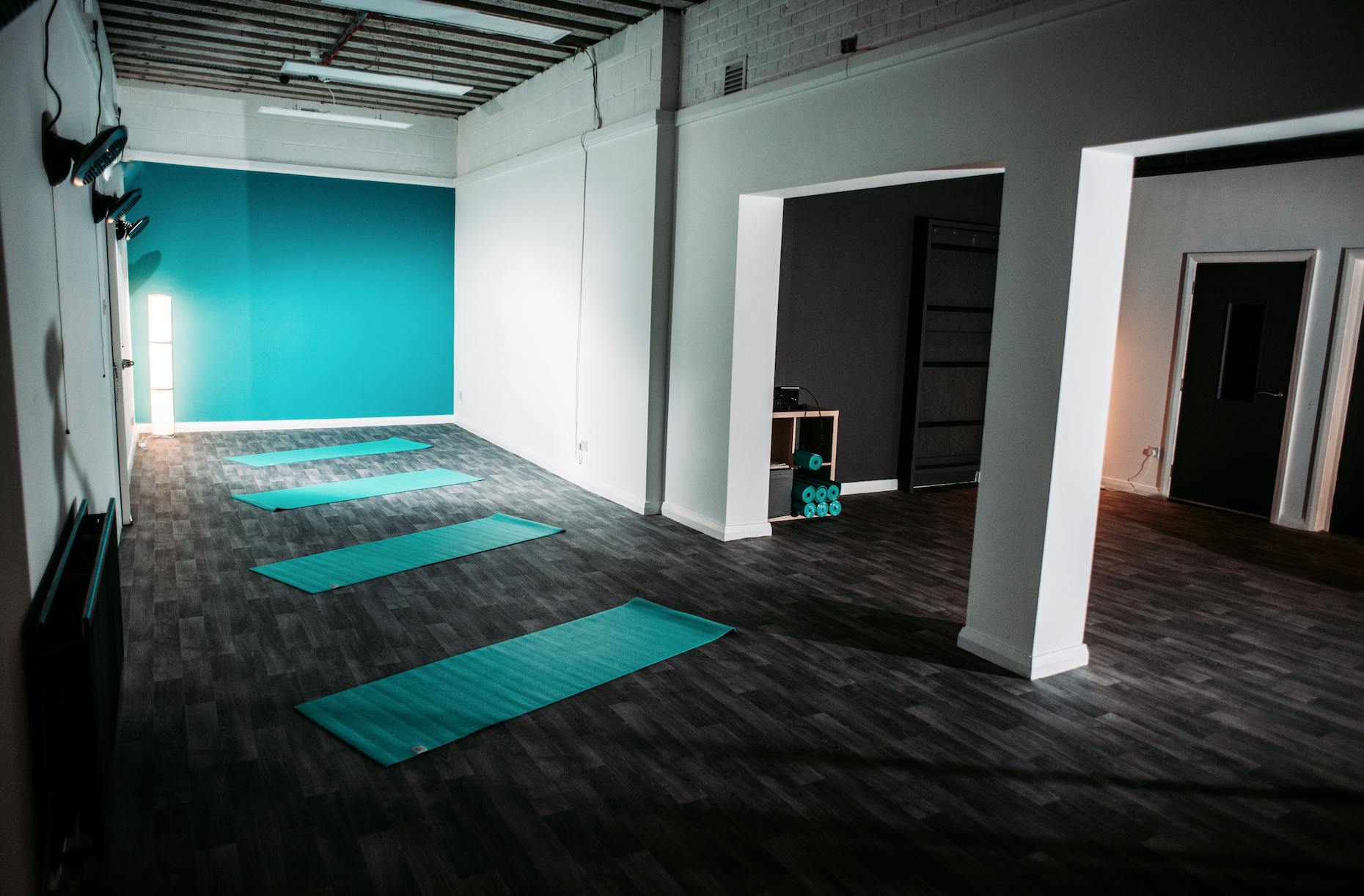 Yoga studio with teal accents, perfect for wellness classes and workshops.