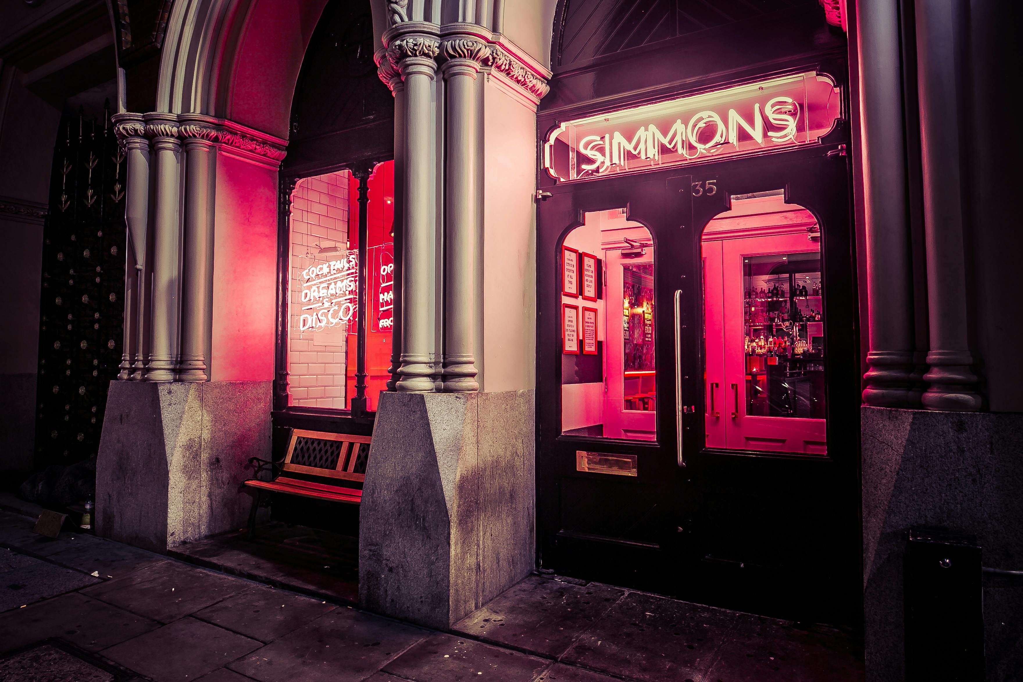 Vibrant venue entrance with neon signage, perfect for networking events and social gatherings.