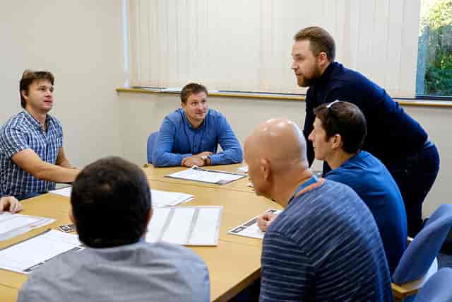 Conference room meeting with engaged participants, ideal for brainstorming and strategy sessions.