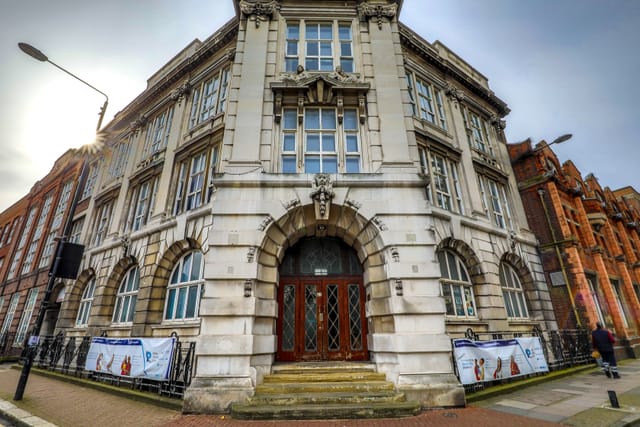 Historic conference room with large windows, ideal for corporate meetings and events.