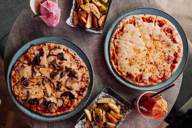 Whole Venue at Caddies Southend with vibrant pizzas and snacks for events and meetings.