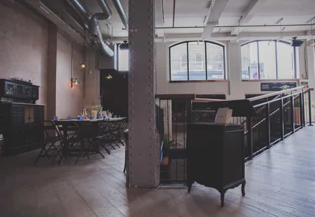 Versatile event space at Pacifica Burger & Cocktail Bar with natural light, ideal for gatherings.