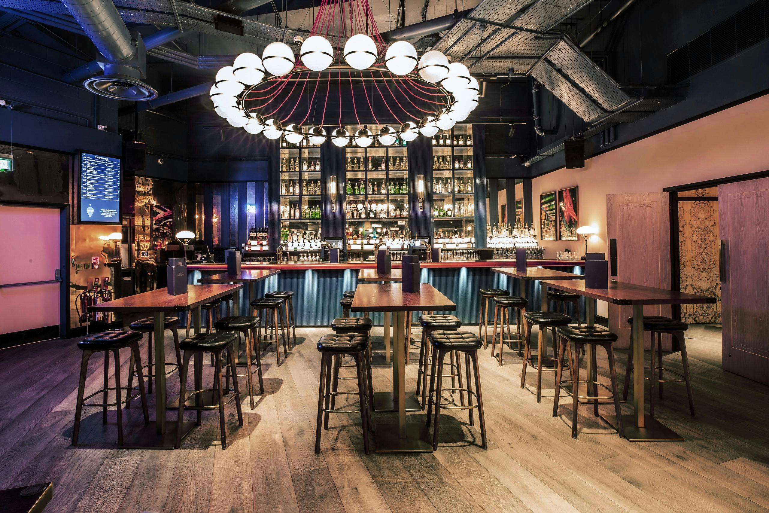 Stylish bar venue at Puttshack Bank for networking events and gatherings.