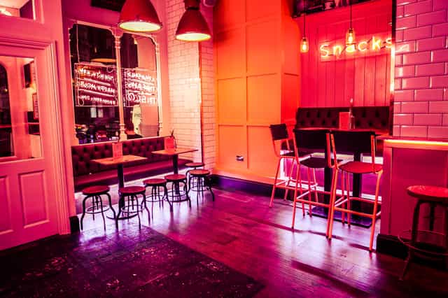 Vibrant modern venue with warm lighting for casual meetings and networking events.