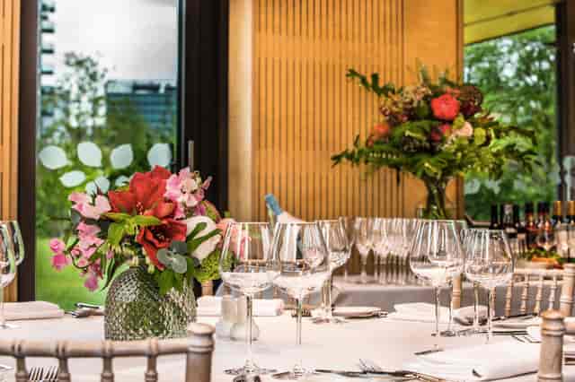Elegant dining table with floral arrangements in Timber Lodge event space. Perfect for gatherings.