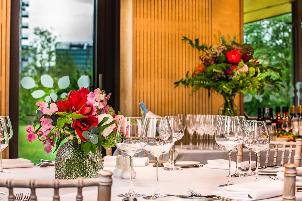 Elegant dining table with floral arrangements in Timber Lodge event space. Perfect for gatherings.