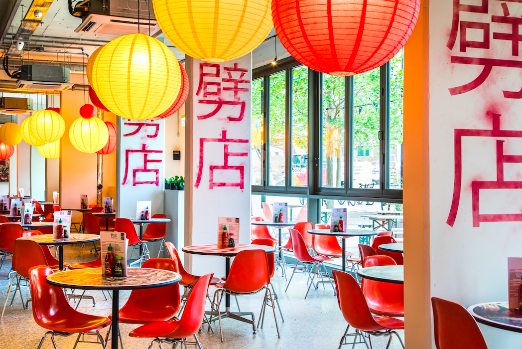 Vibrant event space with colorful lanterns, ideal for networking and workshops. - Banner