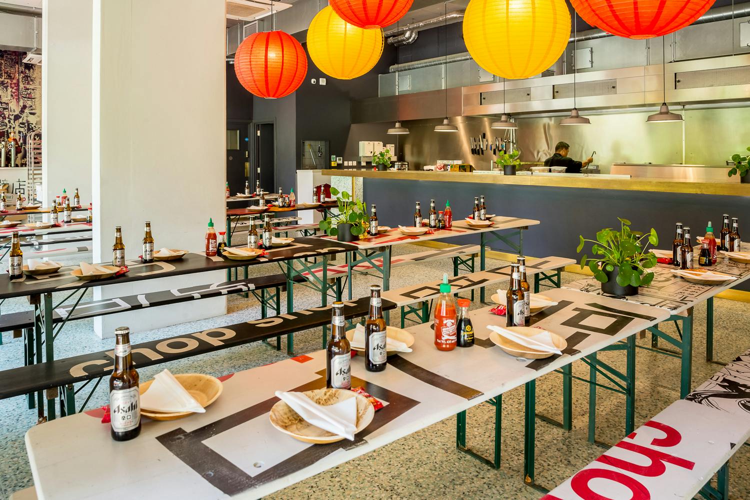Vibrant event space in Chop Shop with communal tables for casual dining and networking.