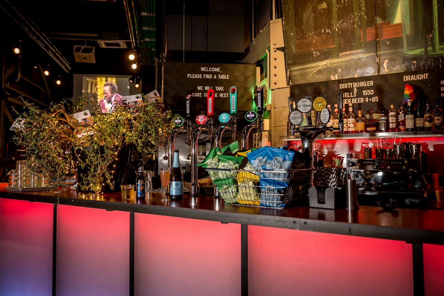 Vibrant bar setup with colorful beer taps for events and socializing at Village Vanguard.