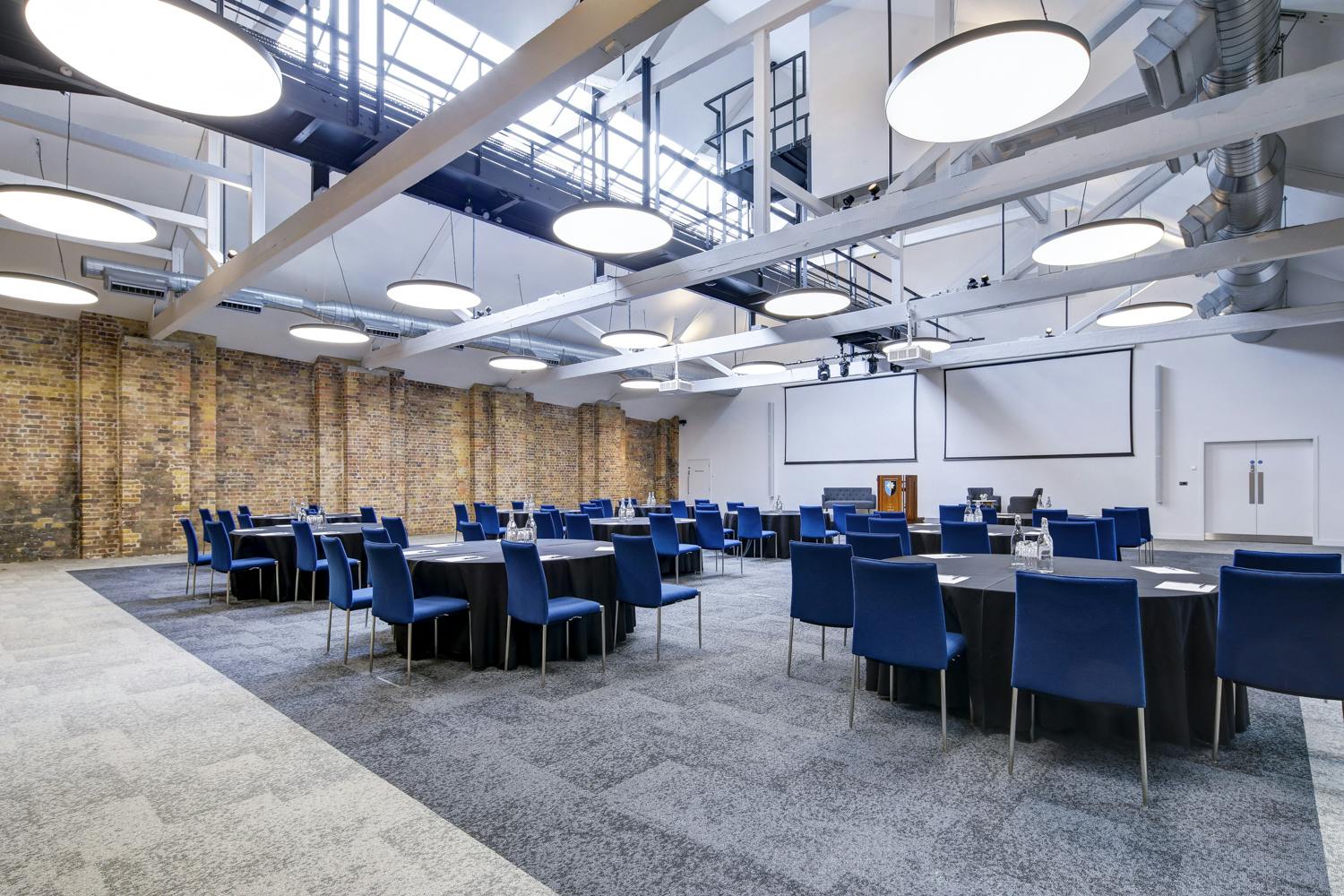 Spacious Main Hall at 10 Union St., featuring exposed brick for meetings and events.