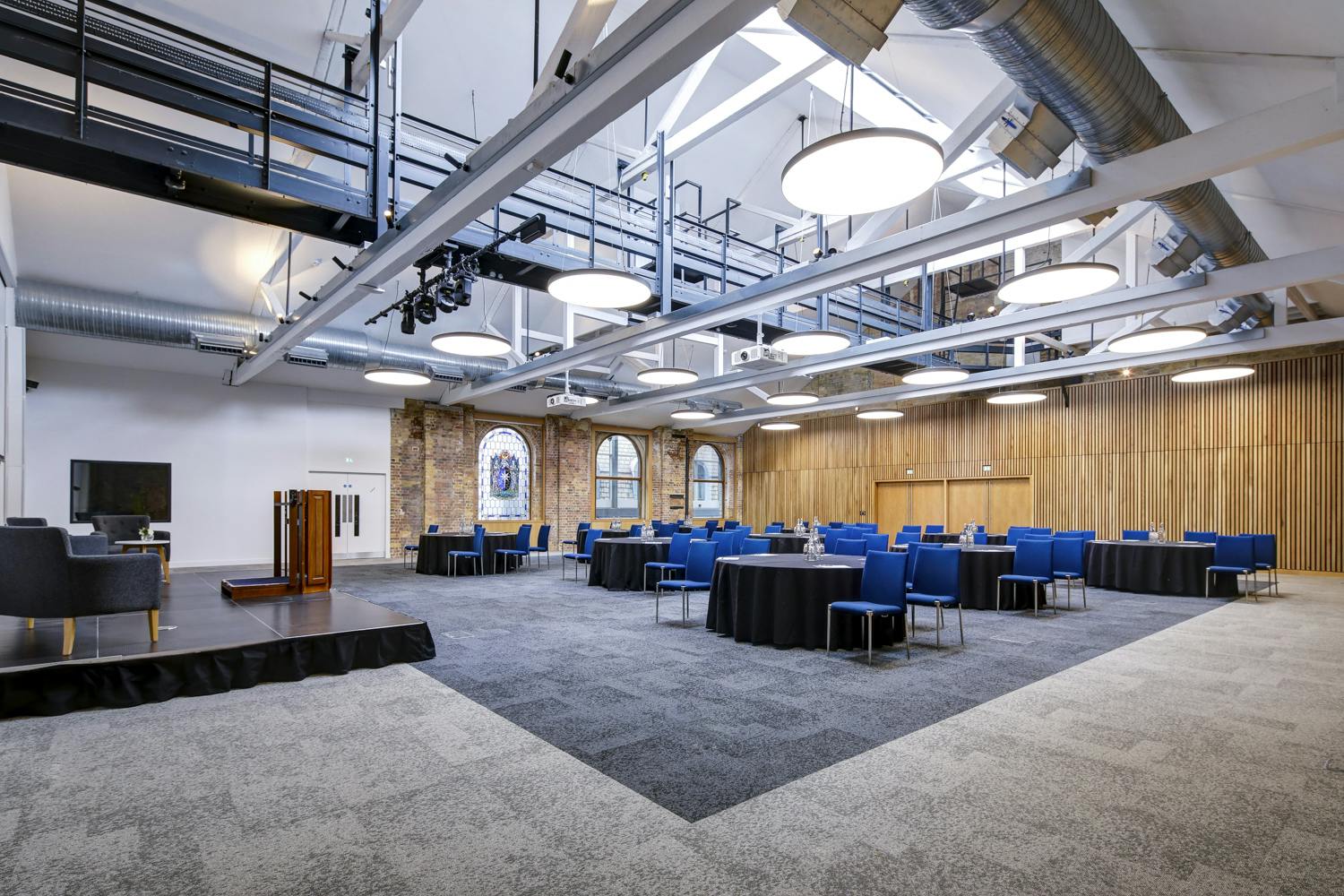 Main Hall at 10 Union St. with round tables, ideal for meetings and social events.