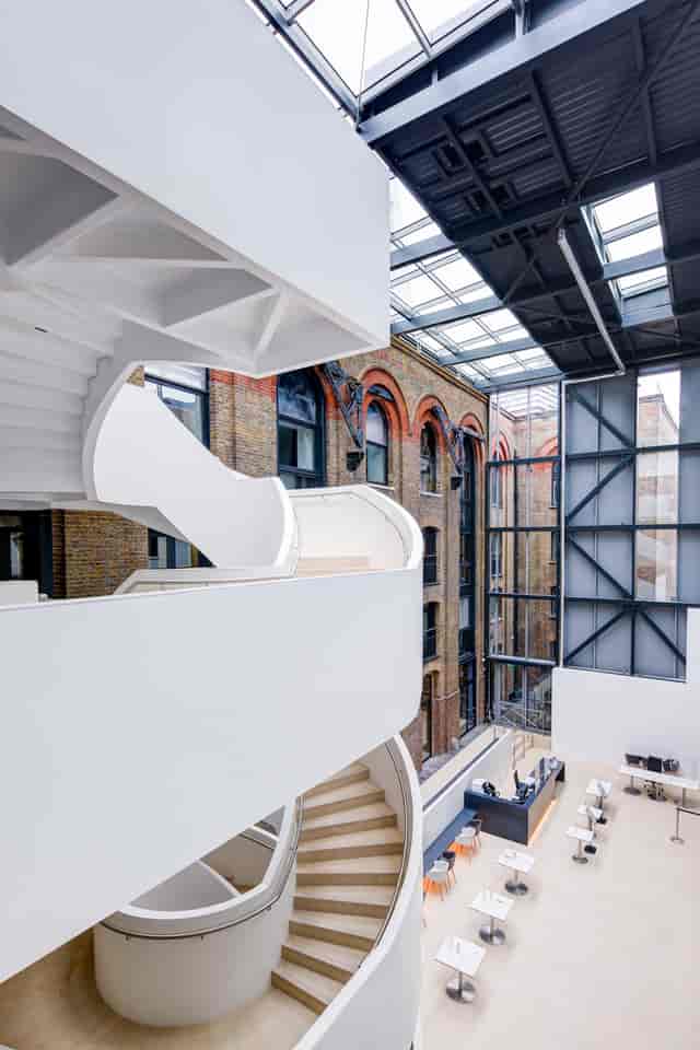 Modern venue with sleek staircase and exposed brick for events and meetings.