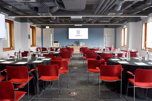 Modern meeting room, round tables, corporate event, presentation space
