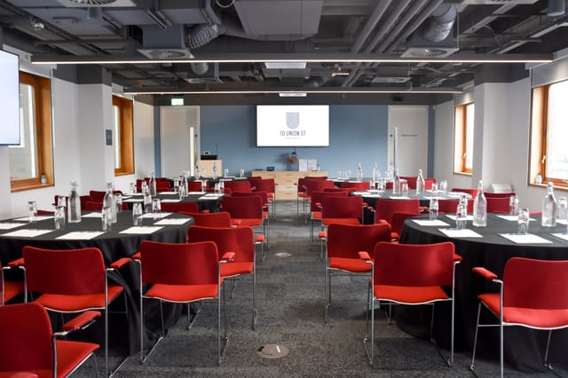 Modern meeting room, round tables, corporate event, presentation space