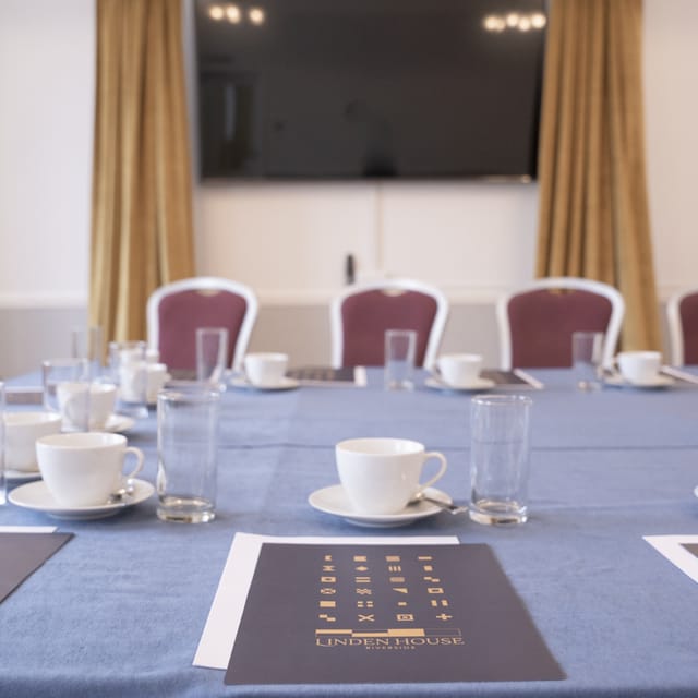 Captains Room at Linden House: elegant meeting space with organized table settings for events.