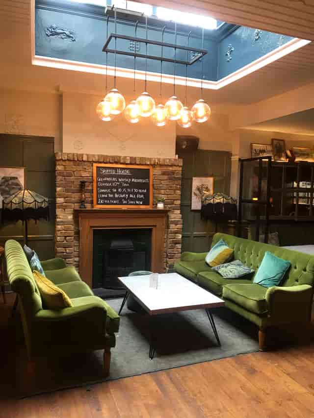 Cozy lounge area with warm lighting, perfect for informal meetings and gatherings.