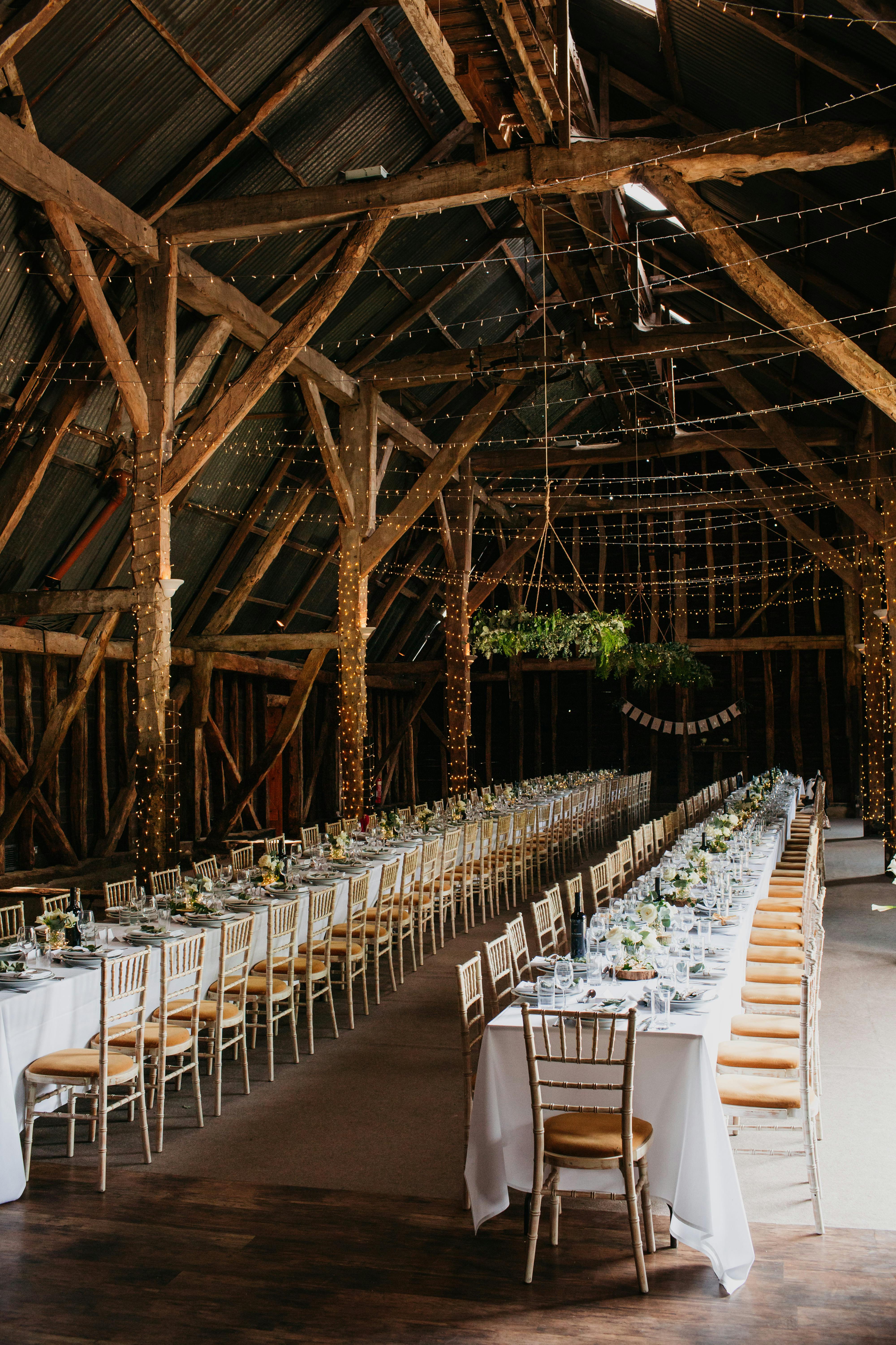 Elegant barn venue with floral centerpieces, perfect for weddings and events.