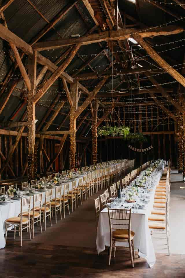 Elegant barn venue with floral centerpieces, perfect for weddings and events.