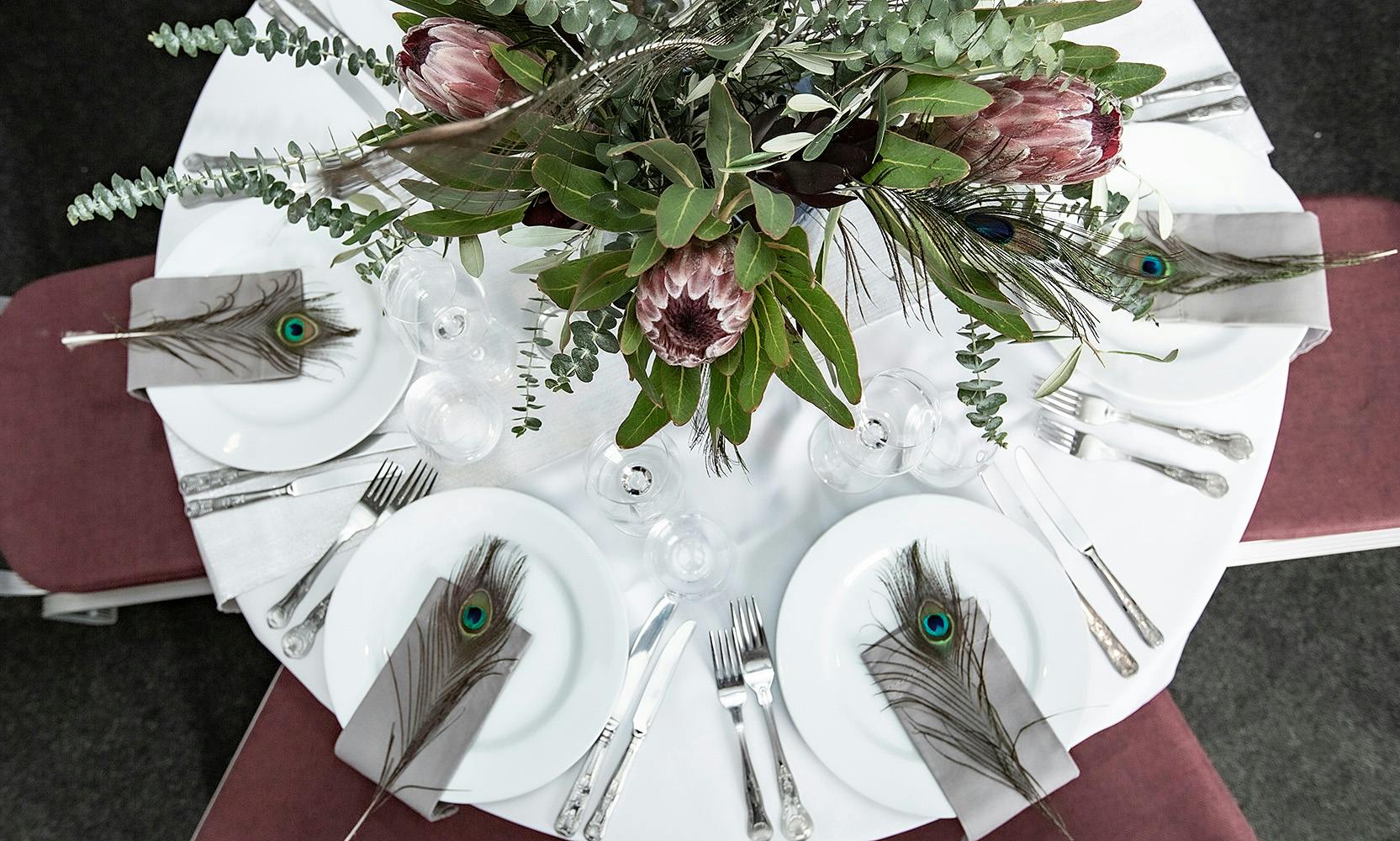 Elegant round table with protea flowers for upscale events at Commodores Room, Linden House.