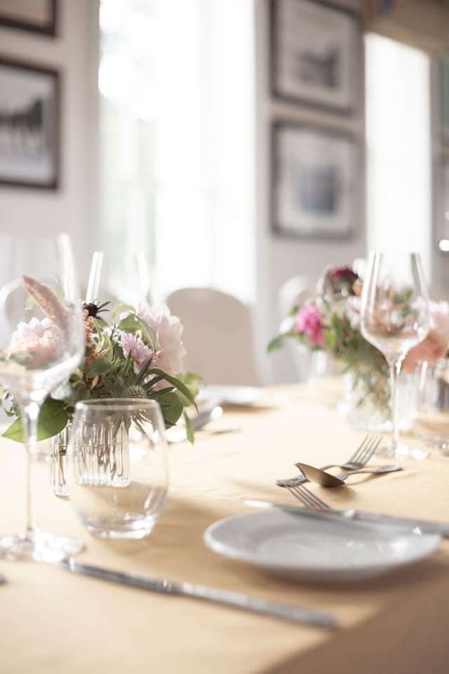 Elegant dining table with floral centerpieces in Linden House for weddings and corporate events.