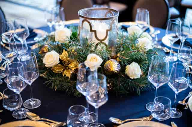 Elegant Christmas party table with white roses and gold accents at Six Park Place.