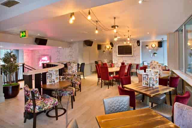 Mezzanine dining area at Slug & Lettuce Manchester, ideal for networking events and team lunches.