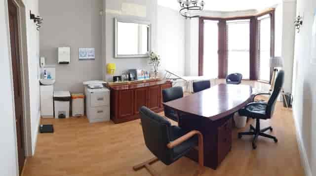 Consultation Room 1 at Best Health Clinics, featuring a large wooden table for meetings.