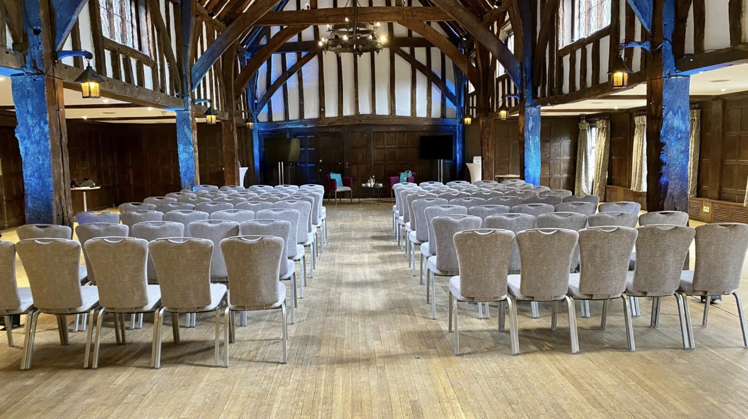 Elegant event space in The Tithe Barn, Great Fosters, ideal for meetings and presentations.